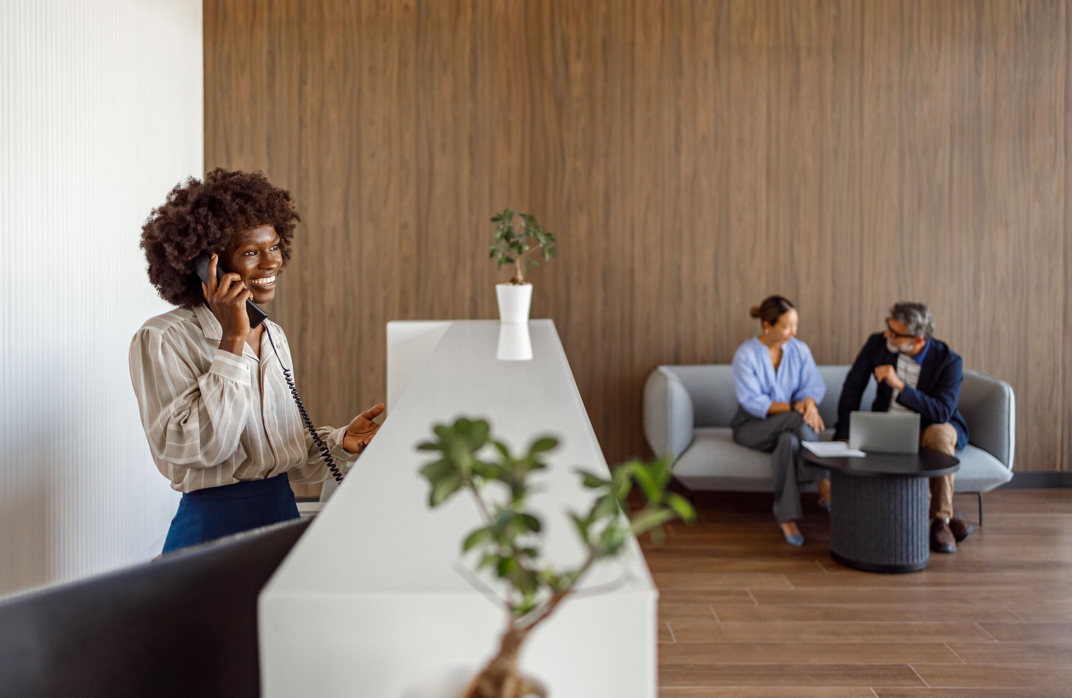 A receptionist speaking with a resident by phone